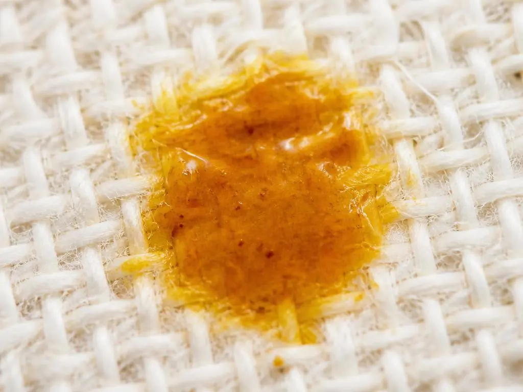 Macro photograph of a stain on white cotton weave